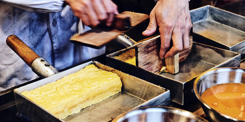 Japanisches Omelett wird in Tamago-Pfanne zubereitet.