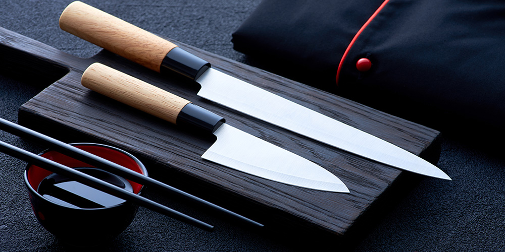 Meat is cut with Asian Santoku knife in the kitchen